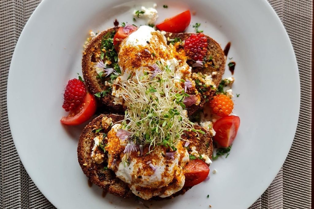 Eggs Benny served from the Nootka Wilderness Lodge with fresh strawberries and salmonberries